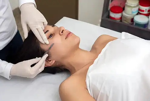 Dermaplaning treatment on clients right side